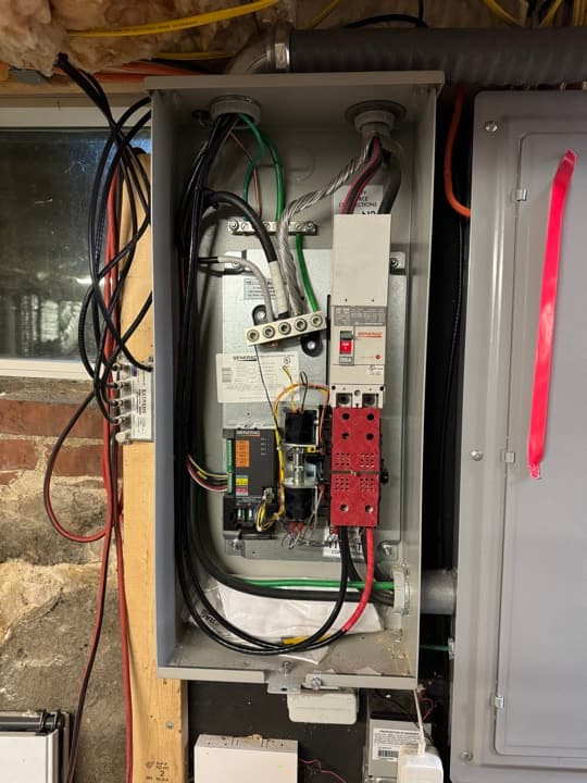Automatic transfer switch interior with surge-protector module, control wiring landed and labeled.