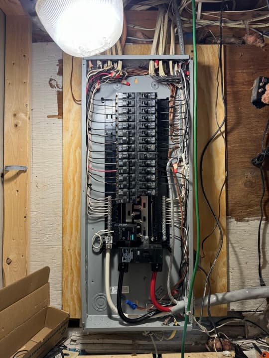 Whole-house residential panel finished with neat homerun routing, every circuit labeled, ground bar bonded cleanly.